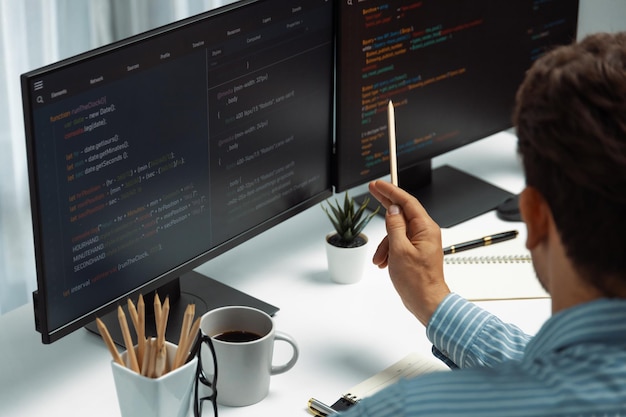 it developer man pointing information center on laptop at back side postulate