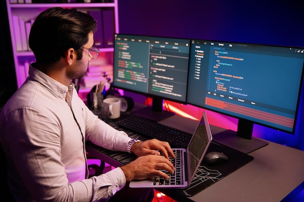 it developer working laptop to search code system at neon light office surmise