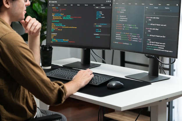 it developer working online software development coding on pc screens gusher