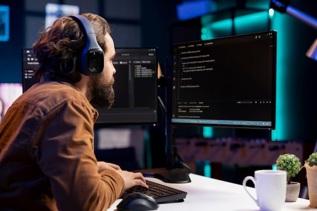 IT programmer listening music while fixing vulnerabilities in software