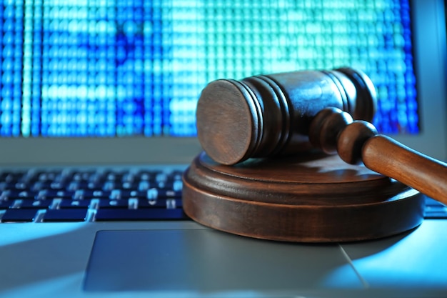 judge gavel on laptop keyboard closeup