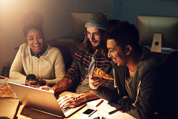 Laptop happy collaboration and night team programming ERP software cyber security system or html code Eating pizza fast food ai developer or programmer teamwork on coding cloud computing database