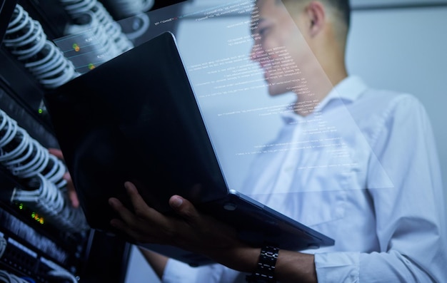 Laptop server room technician and man programming cloud computing network fix cable system or data center Software program code virtual hologram dashboard or IT person upgrade hardware connection