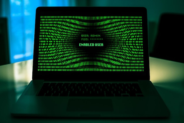 Laptop with green numbers on display successful login password technology protection concept
