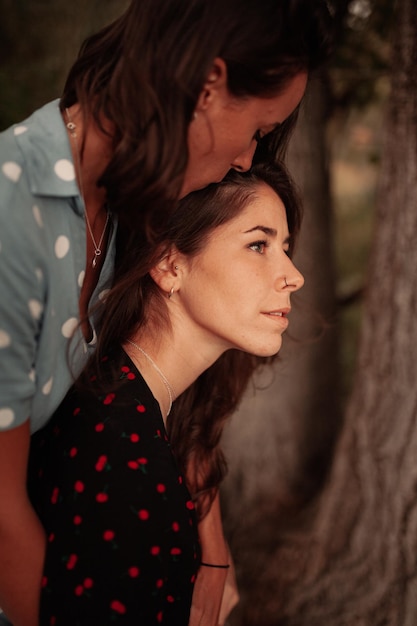 lesbian couple embracing while standing on land