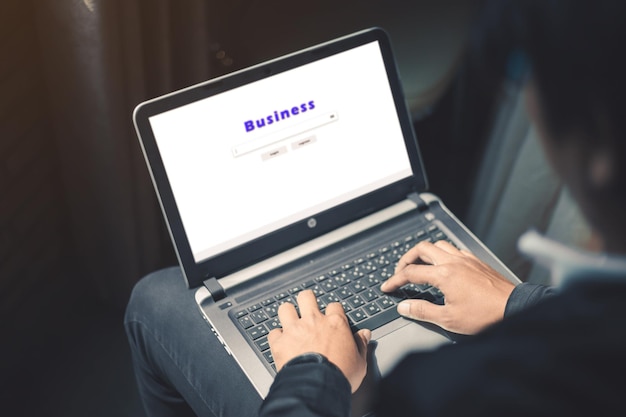Low section of businessman using laptop