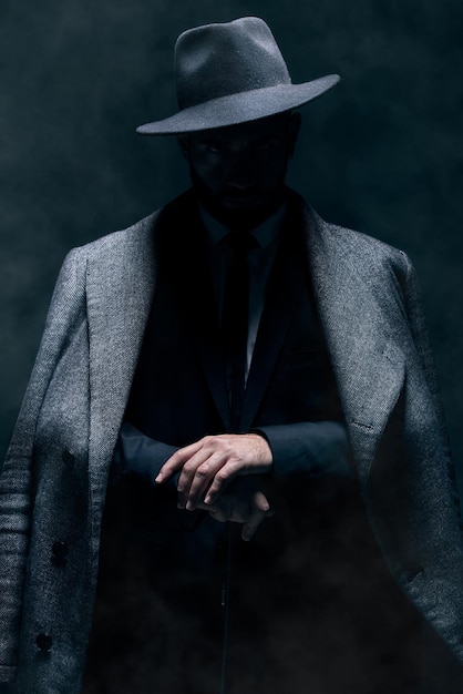 mafia fashion and mystery man in a suit isolated on a dark background in a studio business vintage and stylish secret businessman for crime investigation spy work and agent on a backdrop