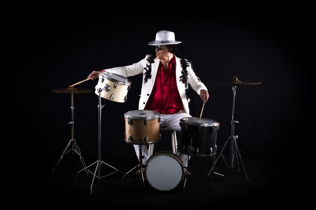 male drummer plays drums on a black background
