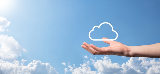 Male hand holding house icon on blue background. Property insurance and security concept.Real estate concept.Weather conditions, cloudiness.Banner with copy space.