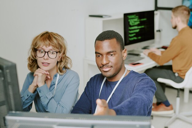 man and woman working together in modern office