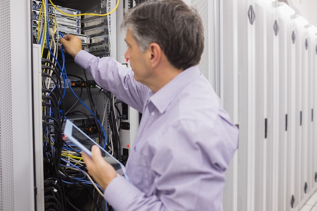 man doing server maintenance with tablet