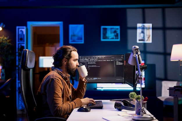 man drinking coffee while doing software quality assurance reading source code