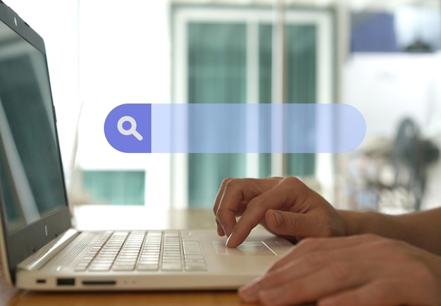 man find information from internet via laptop on table