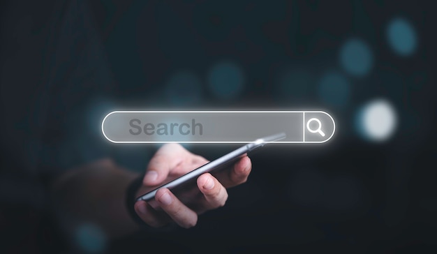 Man hand holding smartphone with virtual screening searching icon for Web search engine concept.