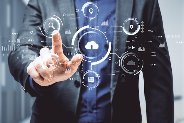 Man hand pointing at abstract business interface on blurry background Cloud computing technology and database concept Double exposure