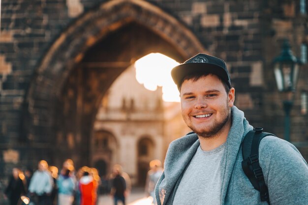 man in front of charles bridge in prague copy space