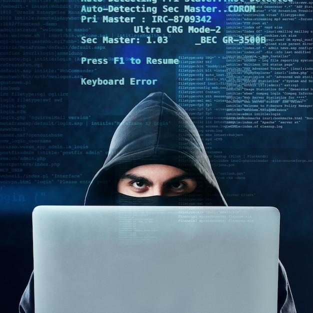 Man laptop and portrait on blue background for hacking phishing and malware error with virus Hacker technology and software for cyber crime programming and cryptocurrency thief with coding