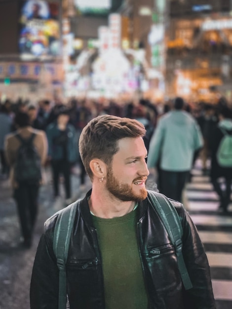 man looking at city street