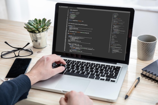 Man programming on a computer office background