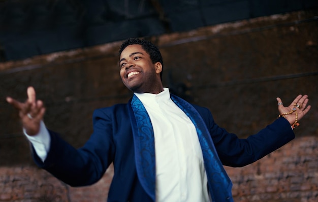 man smiling and entertainment for performance event celebration or musical at carnival or street show african male person and joyful from amsterdam with suit and shirt for concert or opera choir