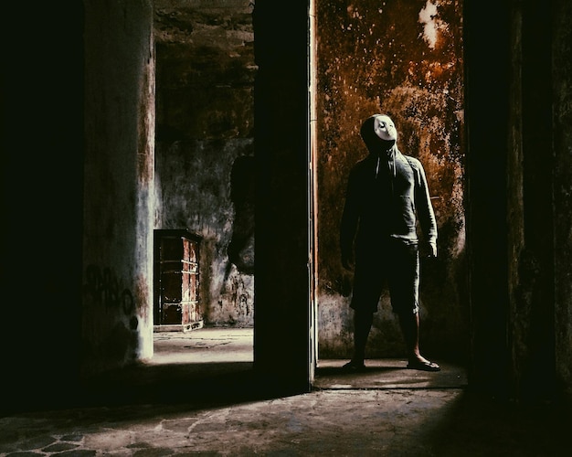man standing in an obsolete building