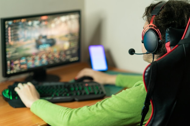 man using computer and mobile phone