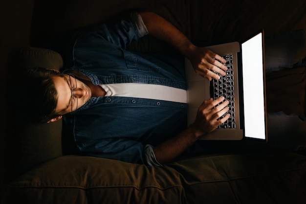 Man working on laptop late at night from home