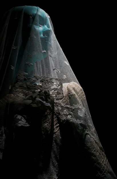 mannequin in wedding dress against black background