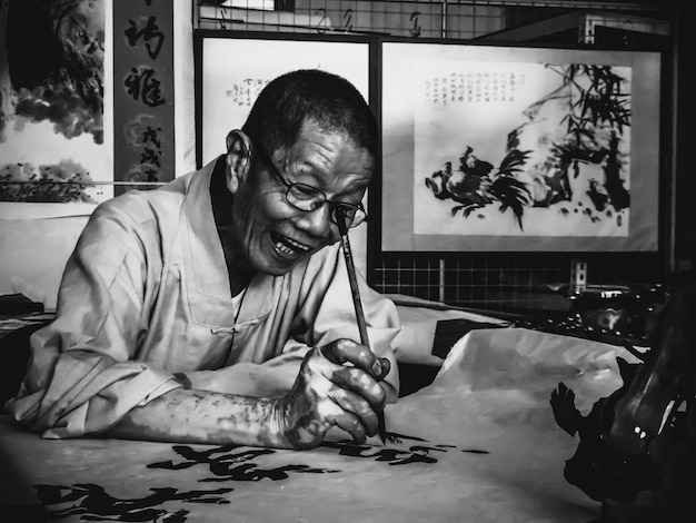 Mature man painting in workshop