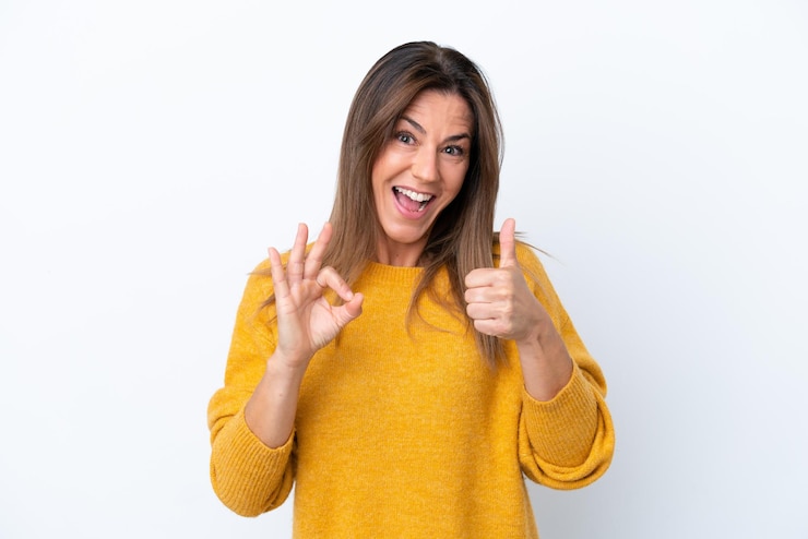 Photo middle age caucasian woman isolated on white background showing ok sign and thumb up gesture