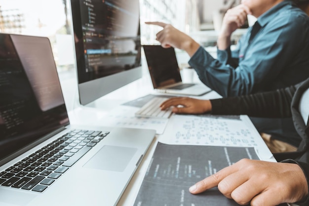 midsection of business people using computers on desk