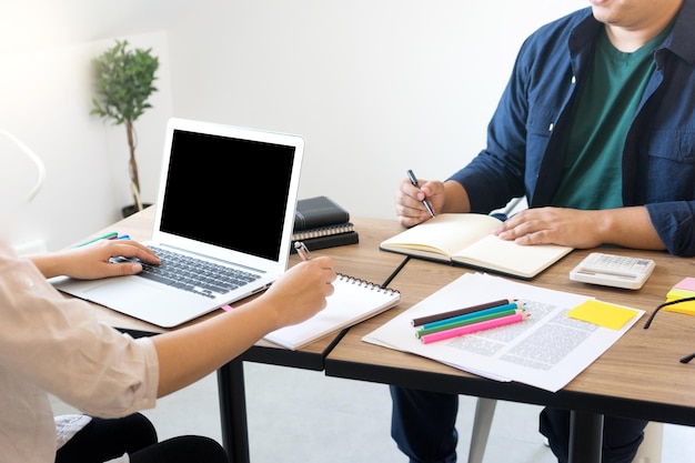 Midsection of colleagues discussing in office