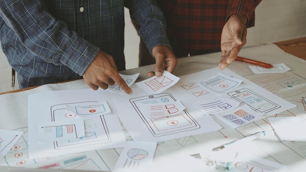 Midsection of design professionals brainstorming in office