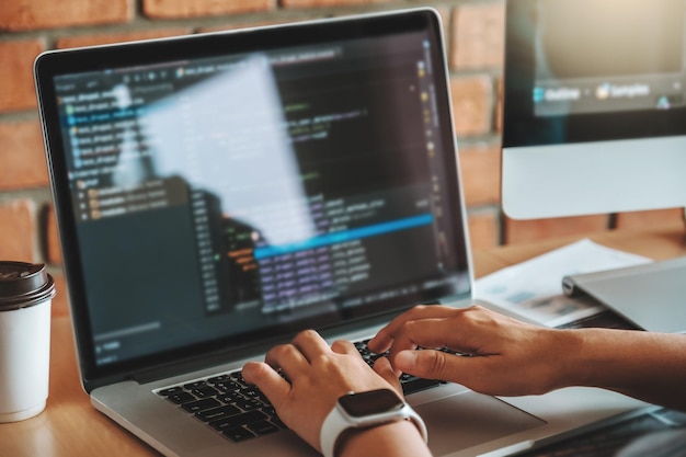 Midsection of person using laptop in office