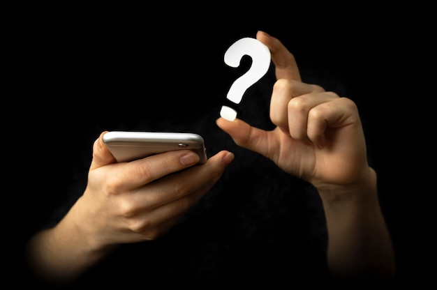 mobile phone and faq symbol. technology, information, service concept. support. black background photo