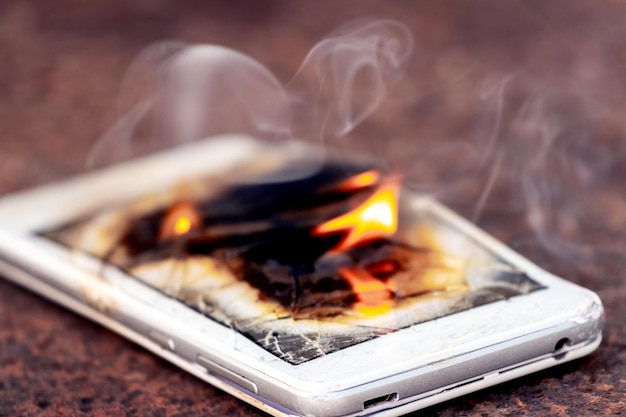 Mobile phone smartphone on fire Burning smartphone