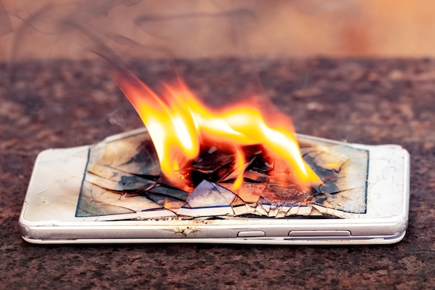 Mobile phone smartphone on fire Burning smartphone