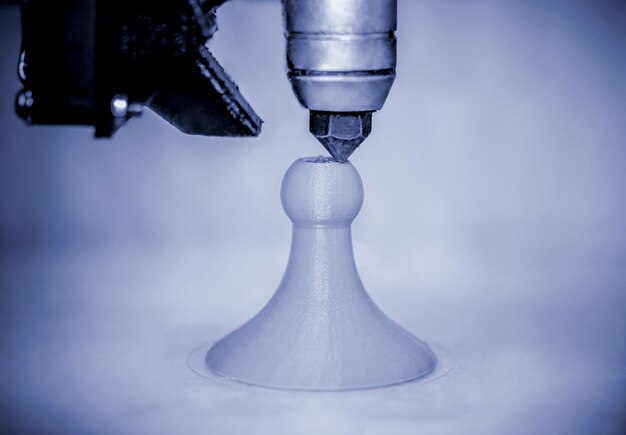 modern 3d printer printing figure blue colors closeup
