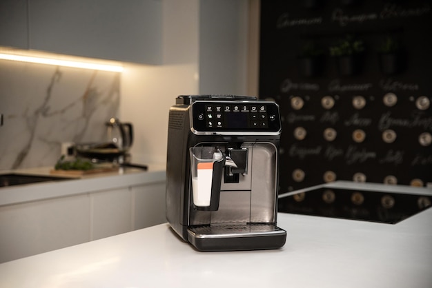 Modern automatic coffee machine on table in kitchen