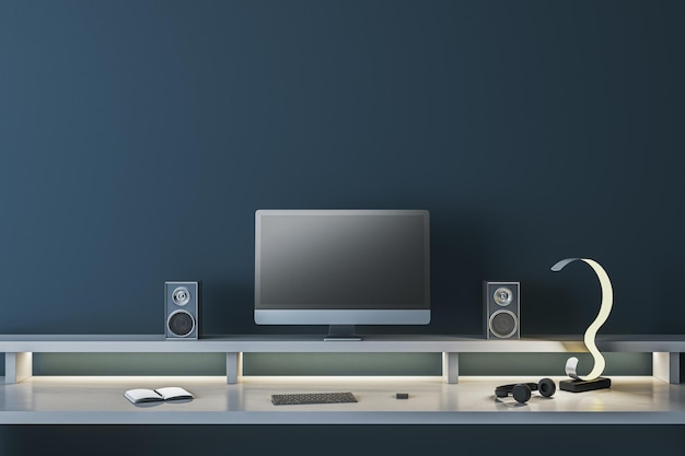 Modern dark blue designer workplace with empty mock up computer screen loud speakers and other items 3D Rendering