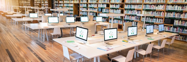 Modern library with rows of computers on white desks Bright spacious library with computers Shelves filled with books in the library setting Modern library with rows of computers