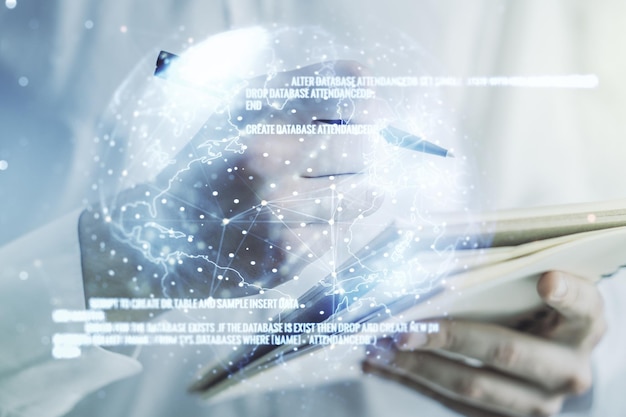 Multi exposure of abstract programming language hologram with world map and man hand writing in notepad on background artificial intelligence and neural networks concept