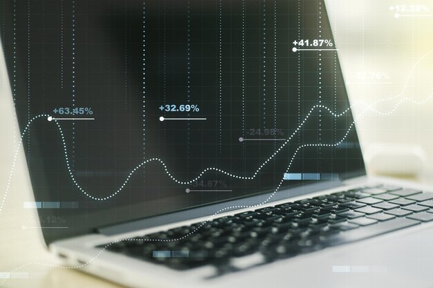 multi exposure of creative statistics data hologram on laptop background stats and analytics concept