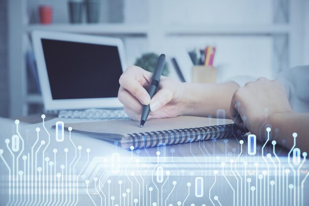 Multi exposure of woman hands on background with technology coding hologram Data concept