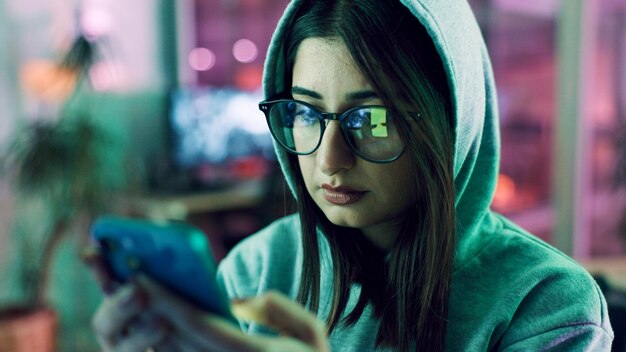 night hacker and woman with smartphone glasses and online reading with cybersecurity programming person reflection or programmer with cellphone website server and eyewear with coding and privacy
