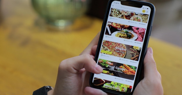 Ordering food using online delivery Man orders food in online store using a smartphone Ordering food using a food delivery app Online delivery online store home delivery