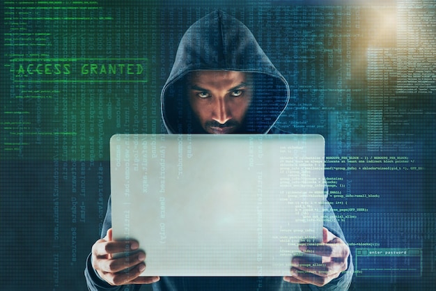 overlay programming and portrait of hacker on laptop for coding virus malware and information technology dark user interface and person on computer for online crime fraud and cybersecurity