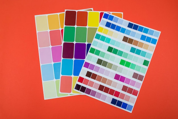 Paper colored catalogs on an isolated orange background Color selection Color palette