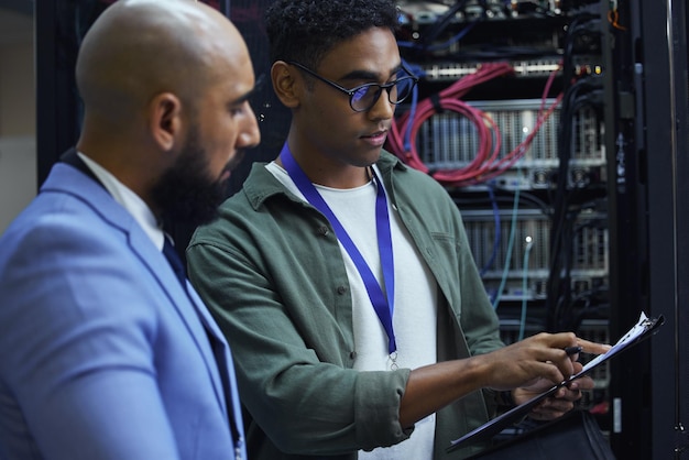 people clipboard and technician engineer in server room employees and programmers with paperwork men colleagues and support for machine maintenance processor hardware and teamwork for system