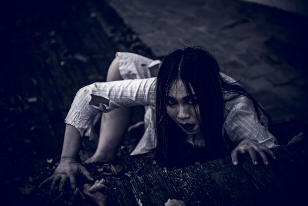 portrait of asian woman make up ghost face with bloodhorror scenescary backgroundhalloween posterthailand peopleghost movies poster